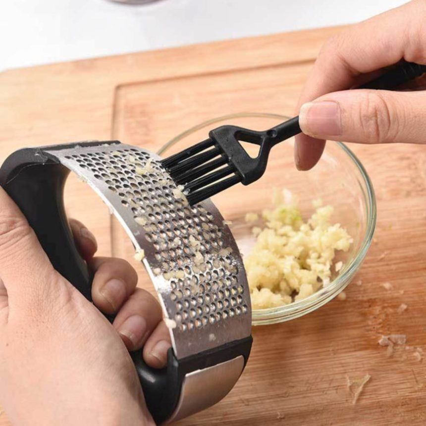 Stainless Steel Manual Garlic Crusher in a Kitchen Setting